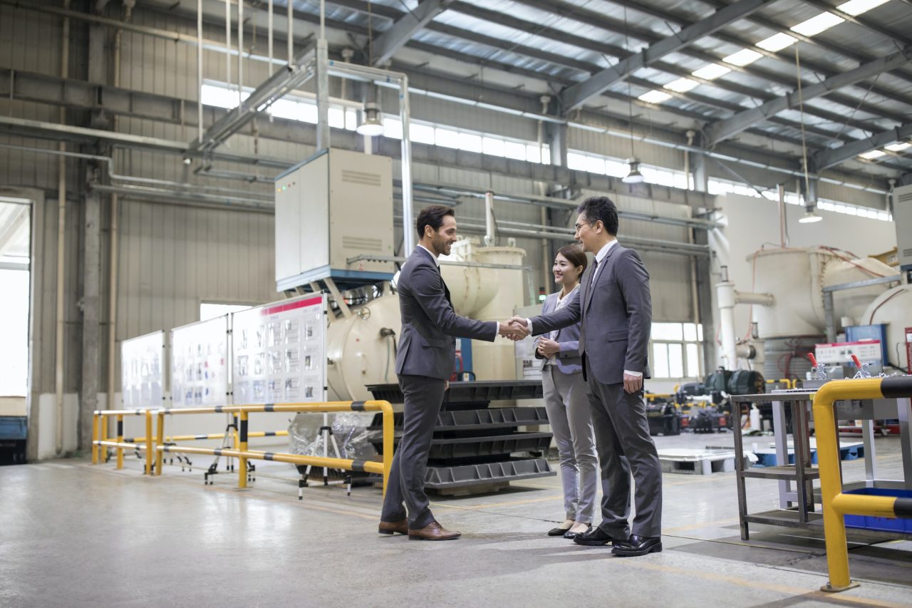 business people shaking hands in the factory.jpg