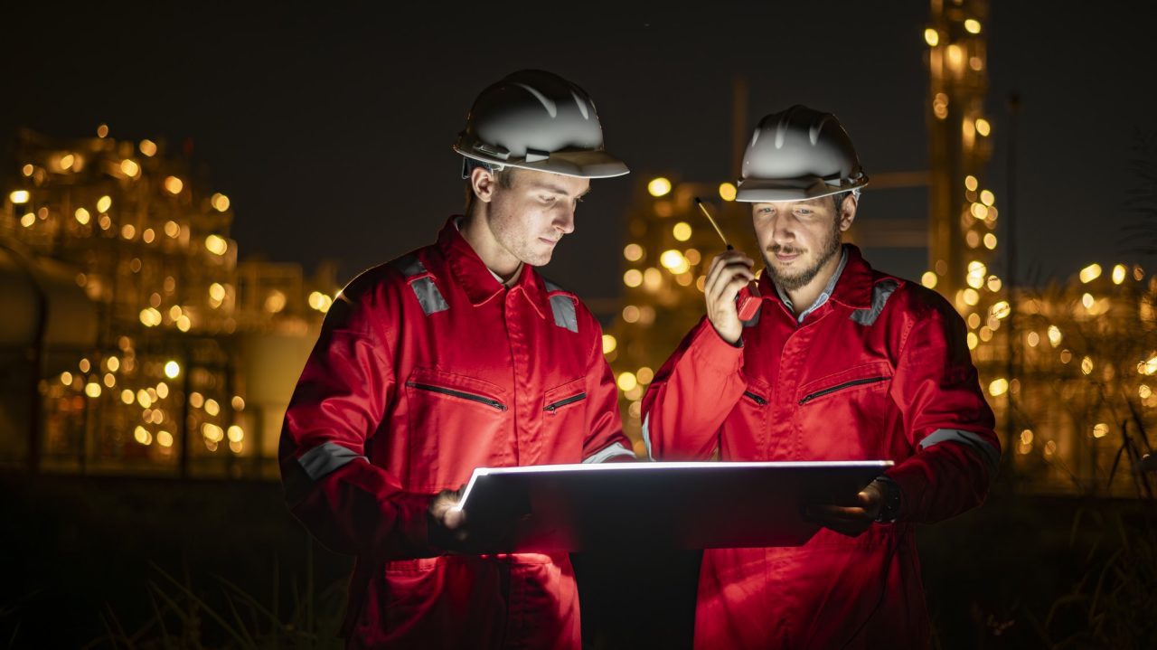 engineer survey team wear uniform and helmet stand workplace checking blueprint project and radio co.jpg